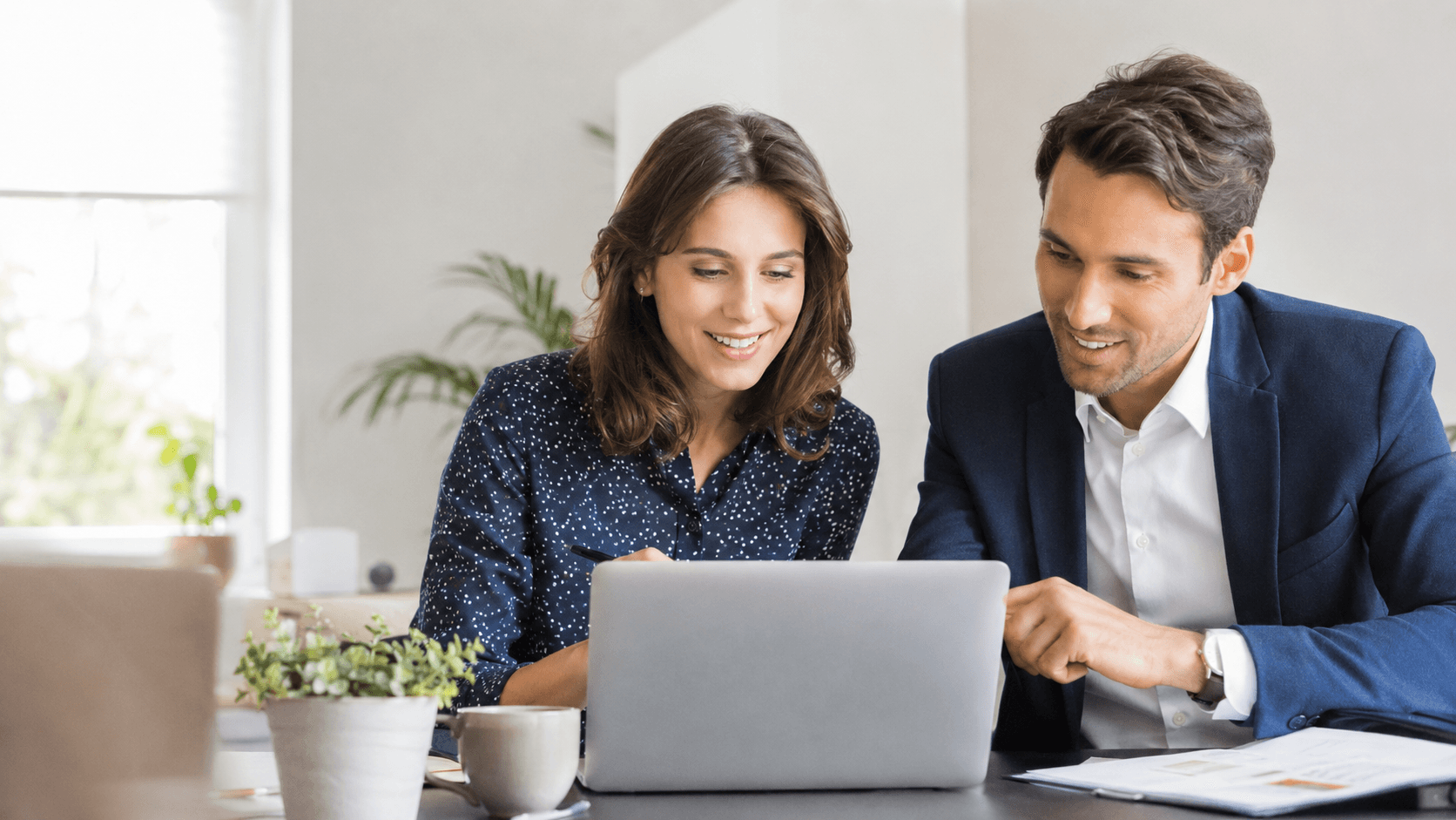 Small business team celebrating a win at a laptop